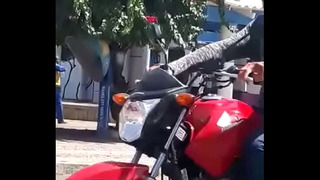 Little bride giving a blowjob in the square in broad daylight